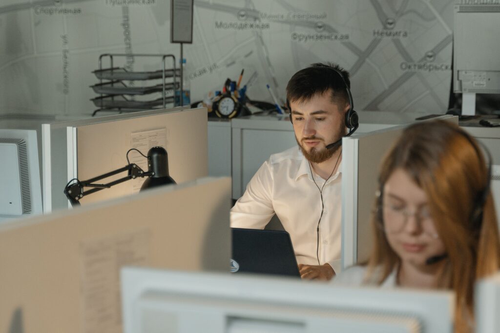 Two colleagues working at computers in an office