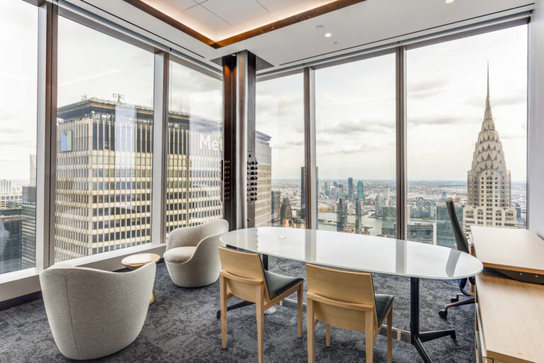 Modern meeting room with floor-to-ceiling windows overlooking the New York skyline